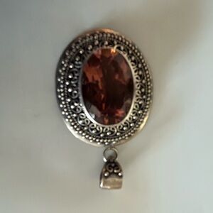 Silver tone necklace pendant with auburn gemstone